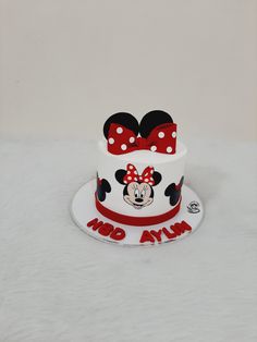 a minnie mouse cake with red bows on top