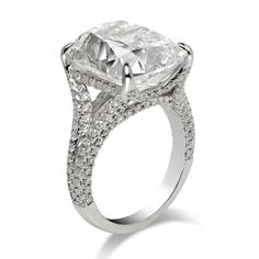 an engagement ring with a cushion cut diamond surrounded by pave diamonds