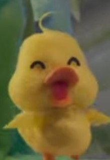 a little yellow duck with its tongue out