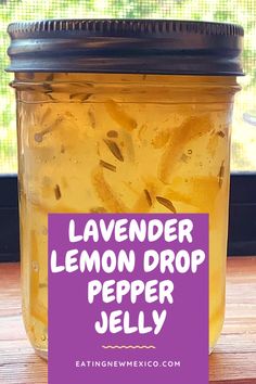 a jar filled with lemon dropper jelly sitting on top of a wooden table