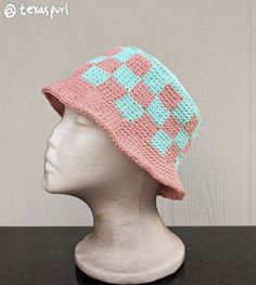 a crocheted hat on top of a mannequin head