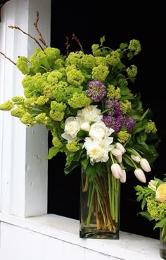 two vases filled with flowers sitting on a window sill