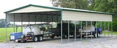 a truck is parked in front of a carport with two tanks attached to it