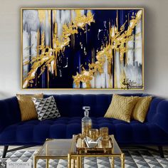 a living room with blue couches and gold accents