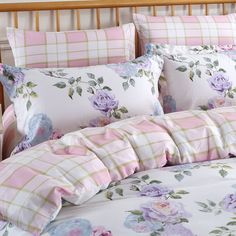 a bed with pink and purple flowers on it