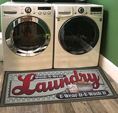 a washer and dryer sitting next to each other in front of a green wall