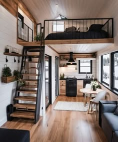 the interior of a tiny home with wood floors and stairs