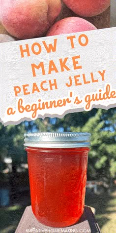 a jar of peach jelly sitting on top of a table next to some peaches