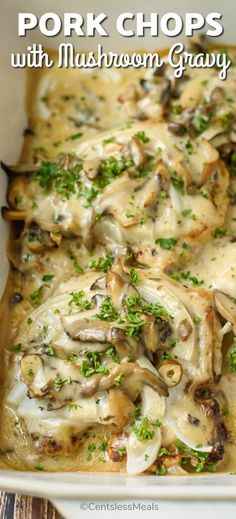 pork chops with mushrooms and gravy in a white casserole dish