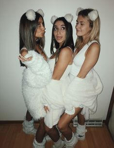 three women dressed in costumes posing for the camera