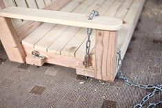 a wooden bench with chains attached to it