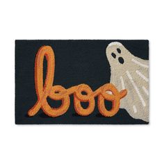 a door mat with the word boo spelled out in front of a ghost and pumpkin