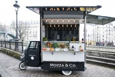 a food cart parked on the side of a street