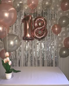 the table is set up with balloons, streamers and a sign that says sis