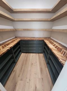 an empty room with wooden flooring and shelves