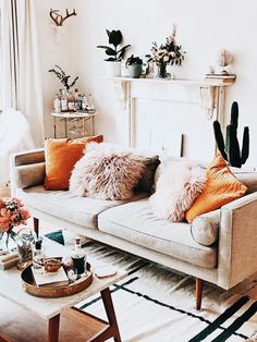 a living room filled with furniture and lots of pillows on top of it's couches