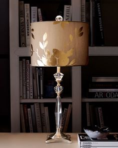 a lamp sitting on top of a table next to a book shelf