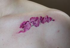 a close up of a person's chest with flowers on it