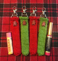 three keychains that have been made to look like they are knitted with red and green yarn