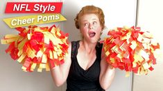 a woman holding two cheer poms in front of her face