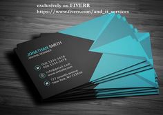 some business cards with blue and black designs on them, sitting on a wooden table