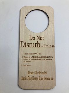 a wooden door hanger that says do not disturb unless