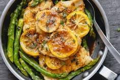 chicken, asparagus and lemons in a skillet