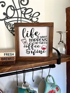 a shelf with coffee mugs and other items on it, including a framed sign