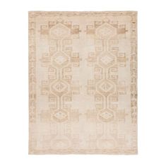 an antique rug with geometric design in beige and brown tones on a white background,