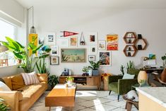 a living room filled with furniture and lots of plants