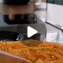 a pan filled with food sitting on top of a kitchen counter next to a stove