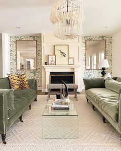 a living room with two couches and a coffee table in front of a fireplace