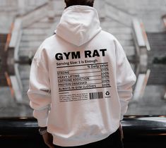 "Introducing our \" Gym Rat Nutrition Fact'' Hoodie--a funny and stylish addition to your gym wardrobe.This hoodie is packed with humor, featuring a playful \"nutrition label\" that proudly declares some gymrats characteristics. HOW TO ORDER: 1. Choose size/color options 2. Select the quantity 3. Click \"Add to Cart\" 4. Proceed to payment HOODIE MATERIAL: - 100% cotton (fiber content may vary for different colors) - Medium fabric - Classic fit - Tear-away label - Runs true to size SIZING: While these Hoodies are unisex and run true to size, we would recommend sizing up 1-2 sizes for an oversized look! CARE INSTRUCTIONS: - Machine wash cold, inside out - Hang dry or tumble dry low - Do not bleach or iron directly on design PROCESSING AND SHIPPING: 3-5 business days for processing Allow 7-1