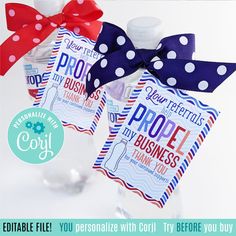 two small bottles with red, white and blue polka dot ribbon tied around the top