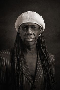 a black and white photo of a woman with dreadlocks