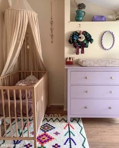 a baby's room with a crib and dresser