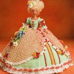 a crocheted doll is wearing a dress with flowers on the bouncy