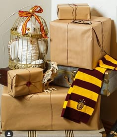 several harry potter gifts are stacked on top of each other, including a birdcage