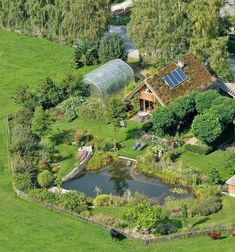 an aerial view of a farm with a pond