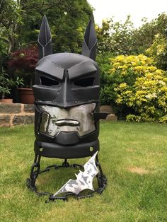 a helmet made out of metal with ears and horns on the head, sitting in grass