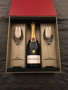 two wine glasses and a bottle in a box