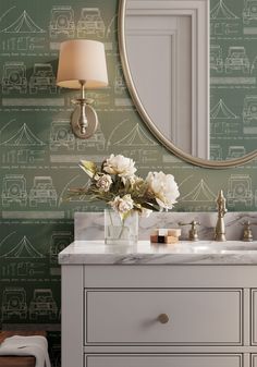 a bathroom vanity with a mirror, sink and flowers on it in front of a wallpapered background