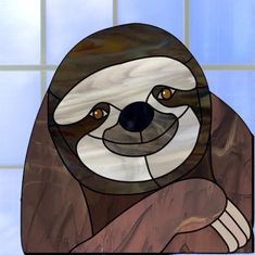 a stained glass window with a slotty bear on it's face and hands