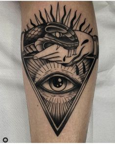 an all seeing eye tattoo on the leg