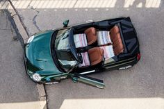 an overhead view of a car parked on the side of the road with its doors open