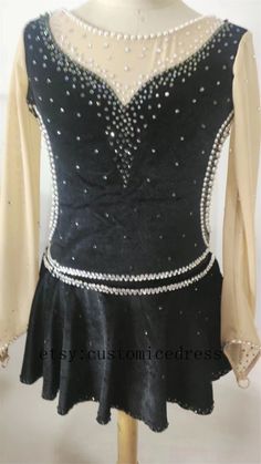 a black and white dress with pearls on it