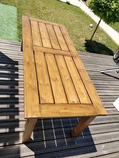 a wooden table sitting on top of a wooden deck