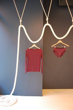 there are two pieces of clothing hanging from ropes