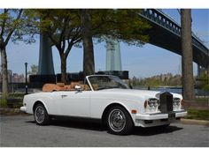 a white car parked in front of a bridge