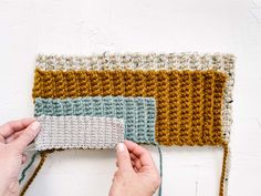 someone is crocheting the sides of a blanket